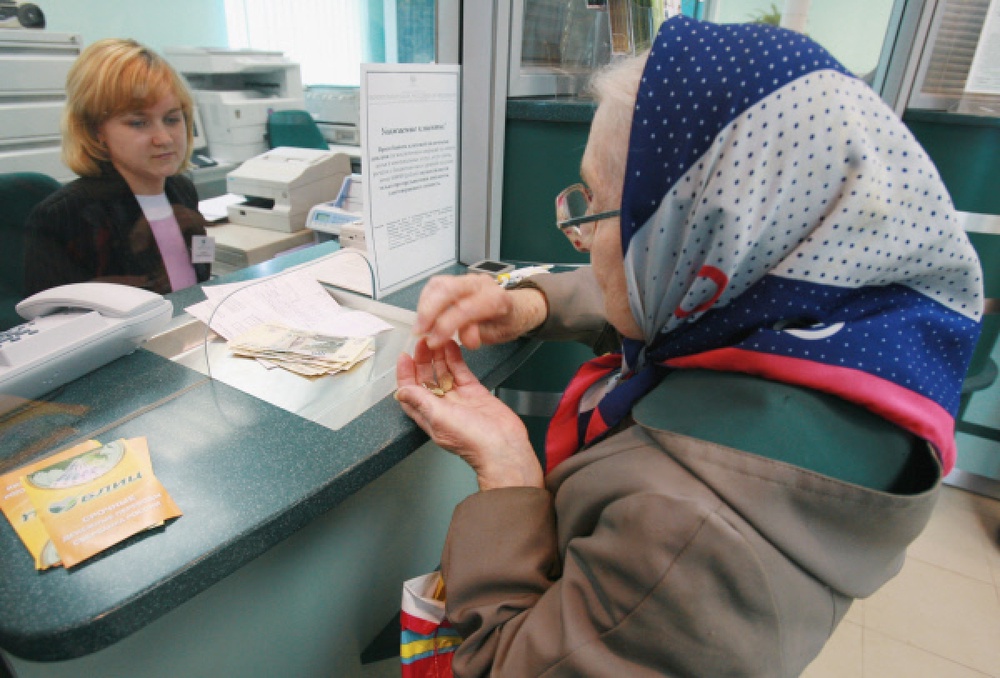 Пенсионерка получает пенсию в банке. Фото ©РИА НОВОСТИ
