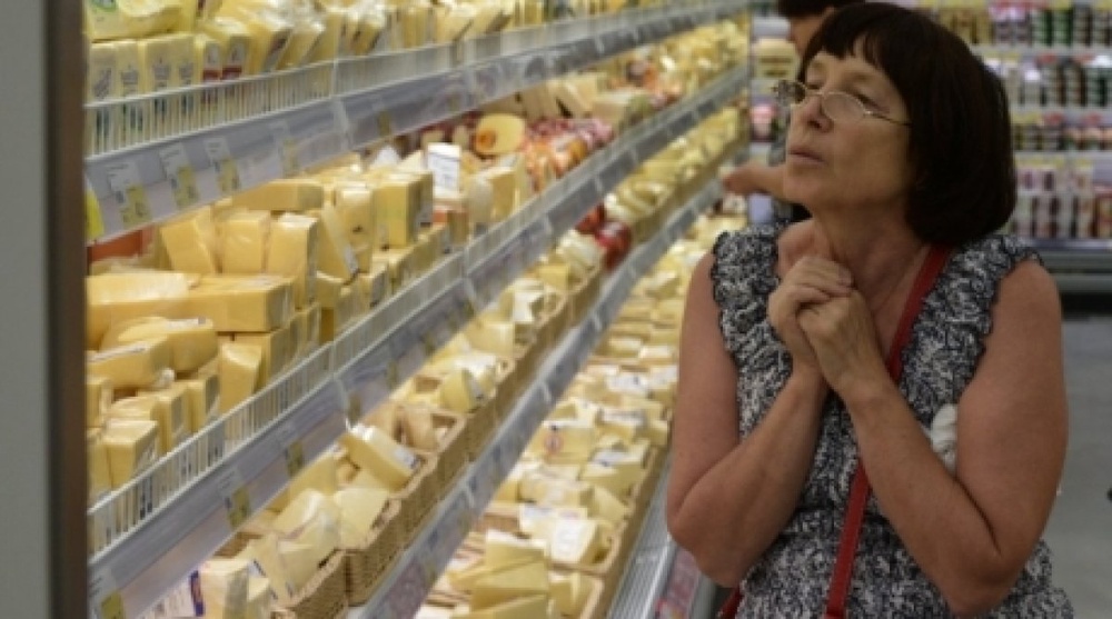 Женщина у прилавка с сырами в гипермаркете Новосибирска. ©РИА Новости