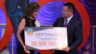 Аким Павлодарской области Асаин Байханов вручает театру сертификат на 50 млн тг