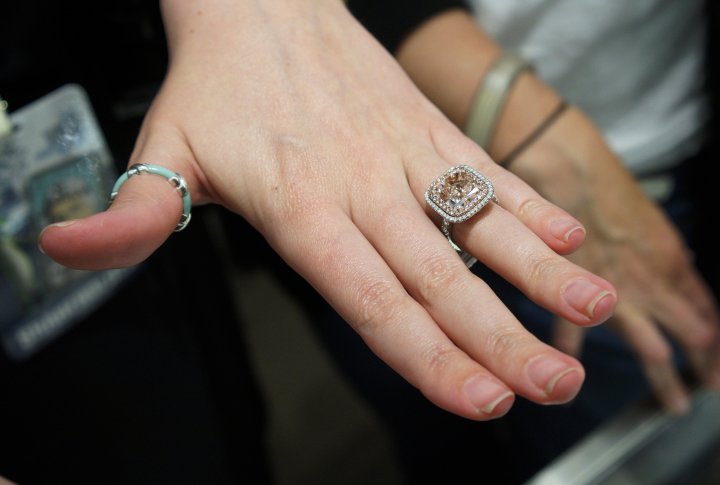 Женщина примеряет кольцо с розовым бриллиантом стоимостью 3,8 миллиона долларов США в ювелирном магазине Berkshire Hathaway в Омахе, штат Небраска, США. ©REUTERS