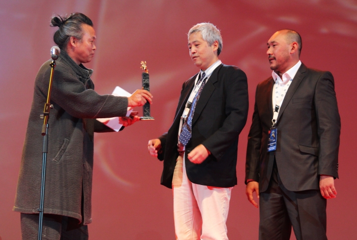 Южно-корейский режиссер вручает главную награду кинофестиваля. <br>Фото: Айжан Тугельбаева©