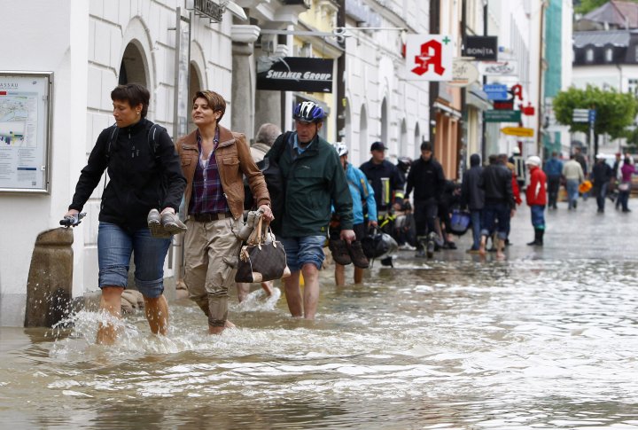 Люди идут по затопленной улице в центре баварского города Пассау. Фото ©REUTERS