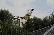 ФОТО: В Астане строительный кран упал на жилой дом