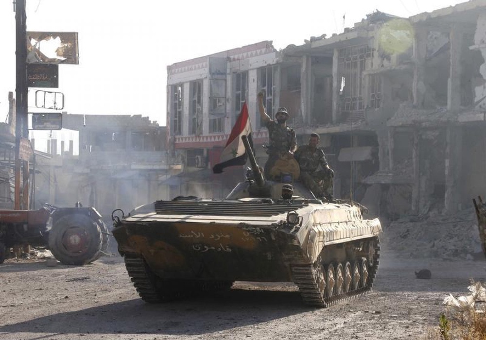 Бронетехника сирийской армии на улицах города Кусейр. Фото ©REUTERS