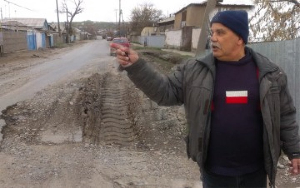 Местный житель рассказывает об ужасных дорогах города. Фото с сайта Otyrar.kz