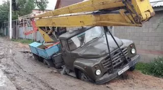 Автомобили проваливаются под землю в Алматы после дождя