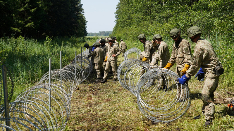 Литовские пограничники устанавливают колючую проволоку на границе с Беларусью. Фото: REUTERS