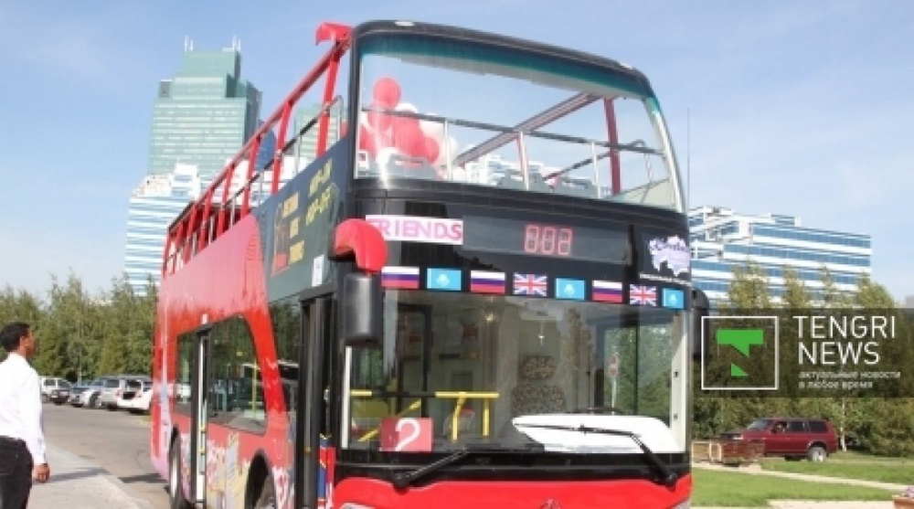 Double-decker sightseeing buses cruise Astana