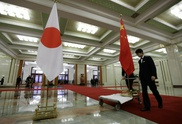 Japan PM urges reset in ties at first meet with China's Xi 