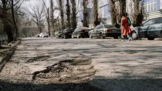 Where to report poor road conditions in Almaty